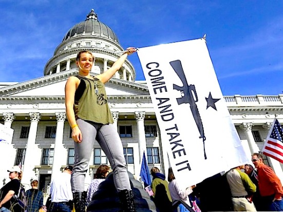 Gun rights activist Holly Cusumano, 18, waves a flag during a rally for the 2nd Amendment at the Utah State Capitol in Salt Lake City on Saturday, March 2, 2013. (AP Photo/Rick Bowmer)