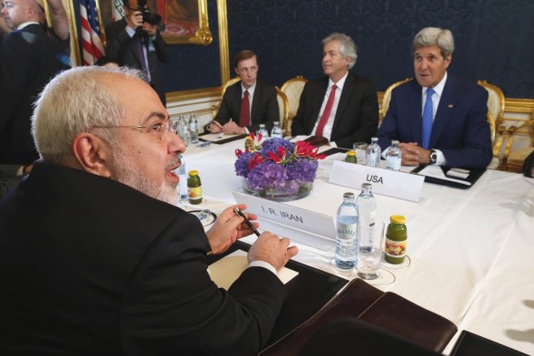 Iran's Foreign Minister Mohammad Javad Zarif, foreground left, met with U.S. Secretary of State John Kerry, background right, in Vienna in July. JIM BOURG
