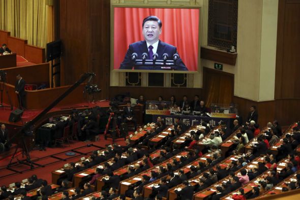 Chinese President Xi Jinping is displayed on a big screen as he delivers a speech at the closing session of the annual National People’s Congress in the Great Hall of the People in Beijing on Tuesday.
